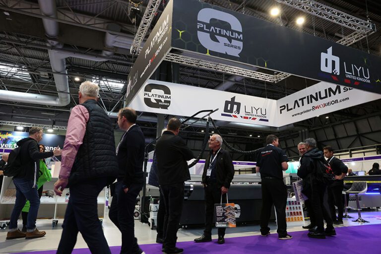 The Liyu UK stand at The Print Show 2023 with crowds walking past and a purple carpet