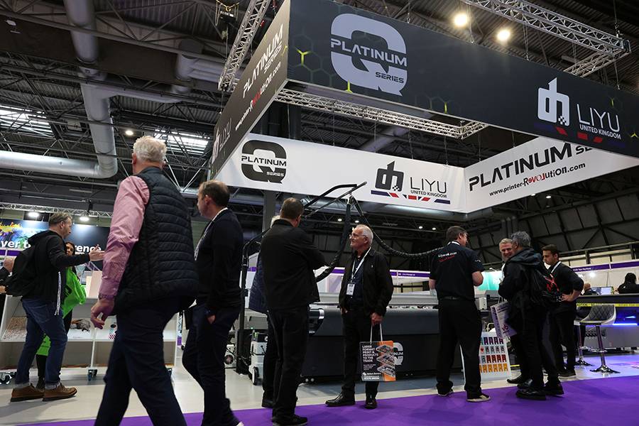 The Liyu UK stand at The Print Show 2023 with crowds walking past and a purple carpet